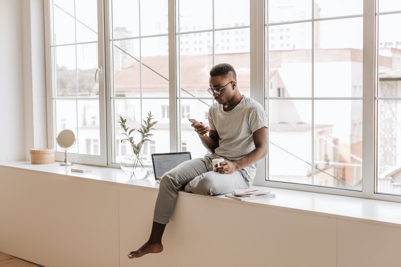 man in open room with lots of windows