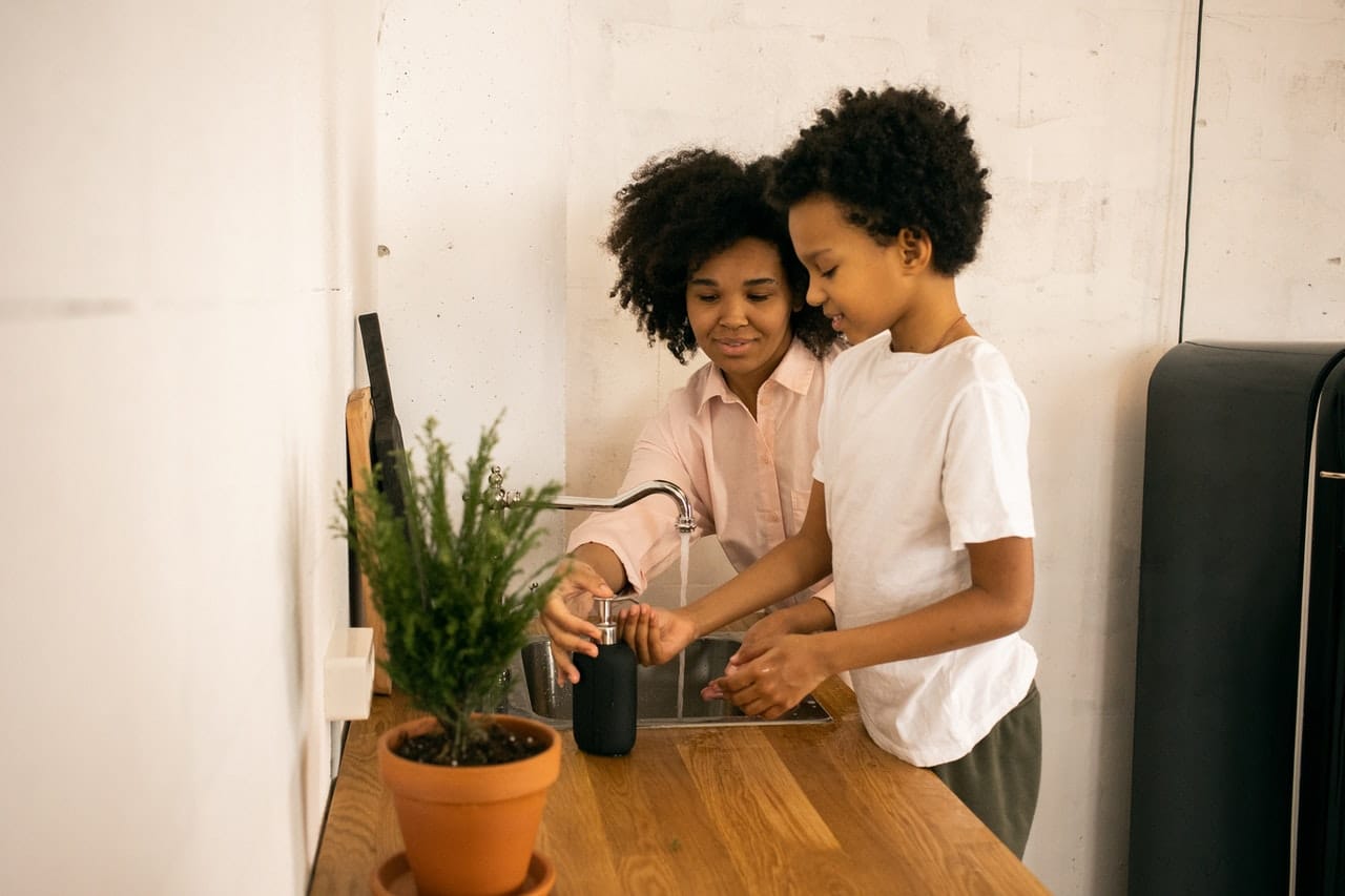 Mother and son washing hands